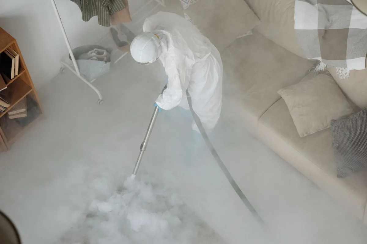 Biohazard cleanup technician in protective equipment, Kalona, IA